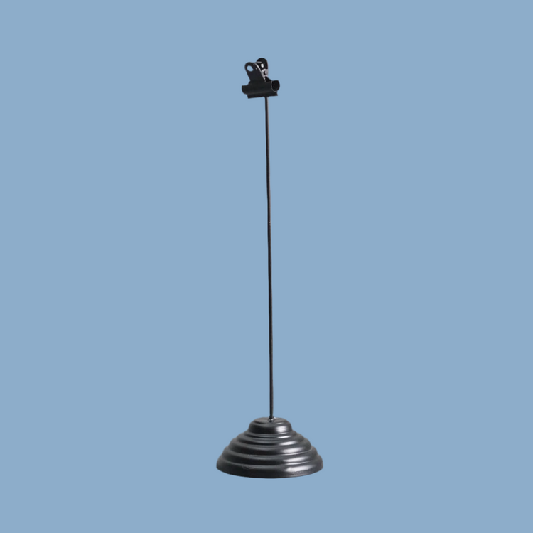 Fotohalter aus Metall in Schwarz vor blauem Hintergrund