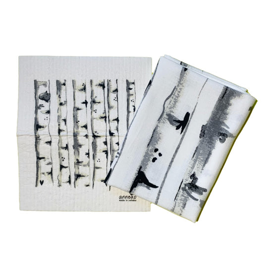 Schwammtuch und Handtuch mit Design Birken nebeneinanderliegend