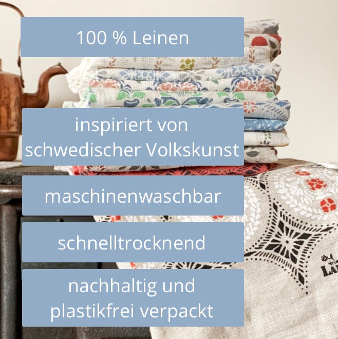 gestapelte Handtücher aus Leinen mit Hinweisen zur Besonderheit des Produkts