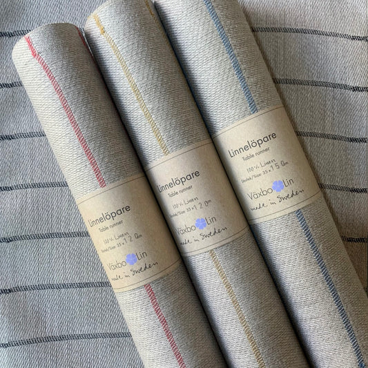 Tischläufer Högbo aus Leinen verschiedene Farben aufgerollt mit Banderole