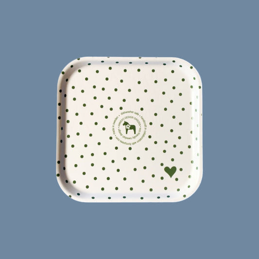 weiße Rückseite (mit grünen Punkten und Annekos Logo) des grünen Tabletts mit weißen Punkten