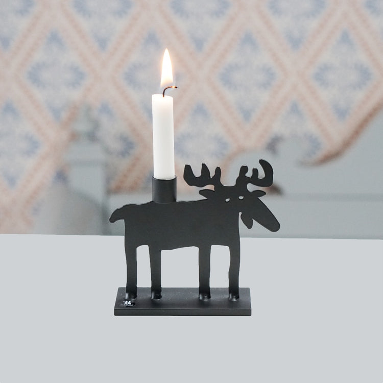 Kerzenstaender aus schwarzem Metall, ausgestanzter Elch auf Grundplatte stehend, auf dem Rücken eine Kerzentüle für Christbaumkerzen