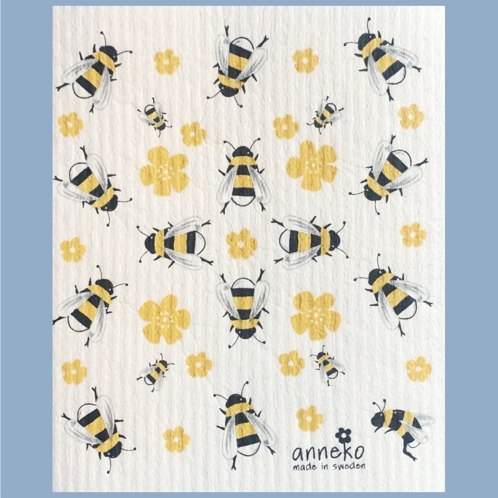 Große und kleine illustrierte Bienen in gelb und schwarz sind durcheinander auf dem Schwammuch verteilt, dazwischen einige gelbe Blüten