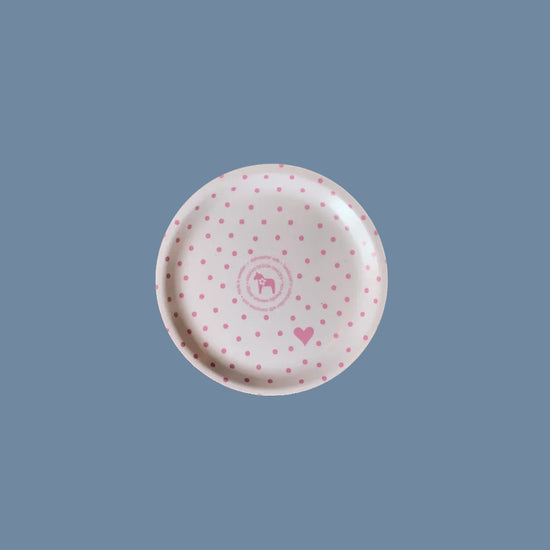 Rückseite des Glasuntersetzers aus Holz mit Punkten grün vor mysblauem Hintergrund