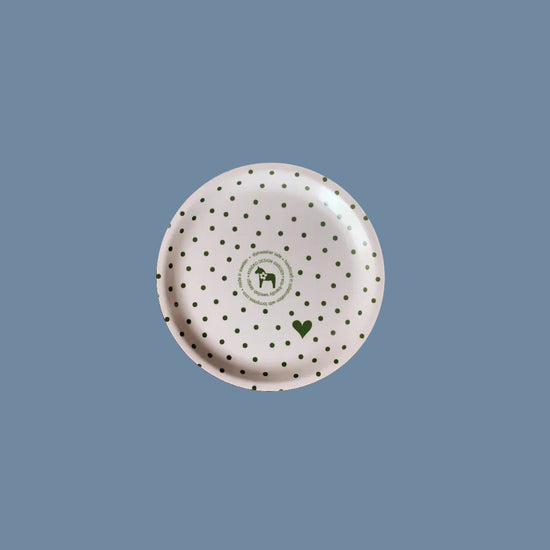 Rückseite des Glasuntersetzers aus Holz mit Punkten grün vor mysblauem Hintergrund