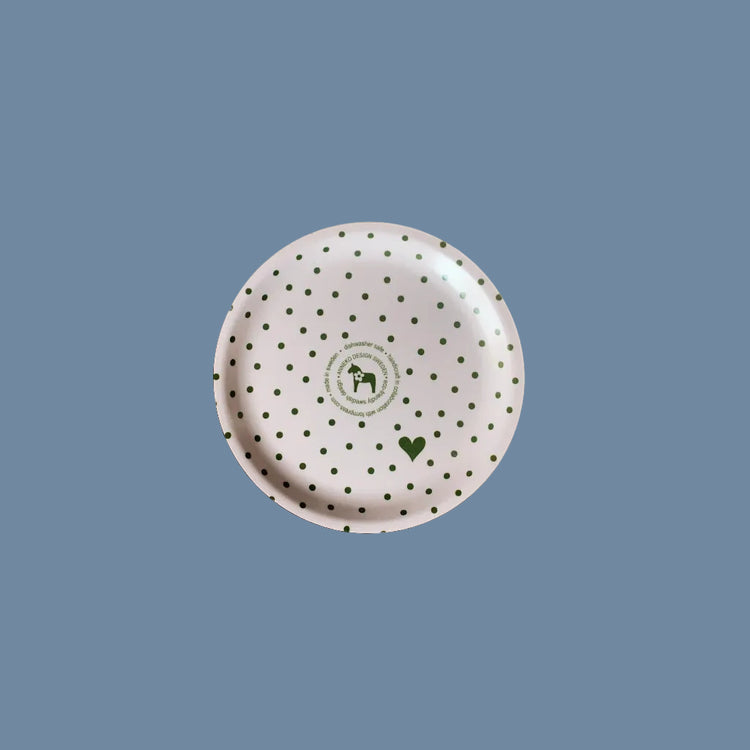 Rückseite des Glasuntersetzers aus Holz mit Punkten grün vor mysblauem Hintergrund