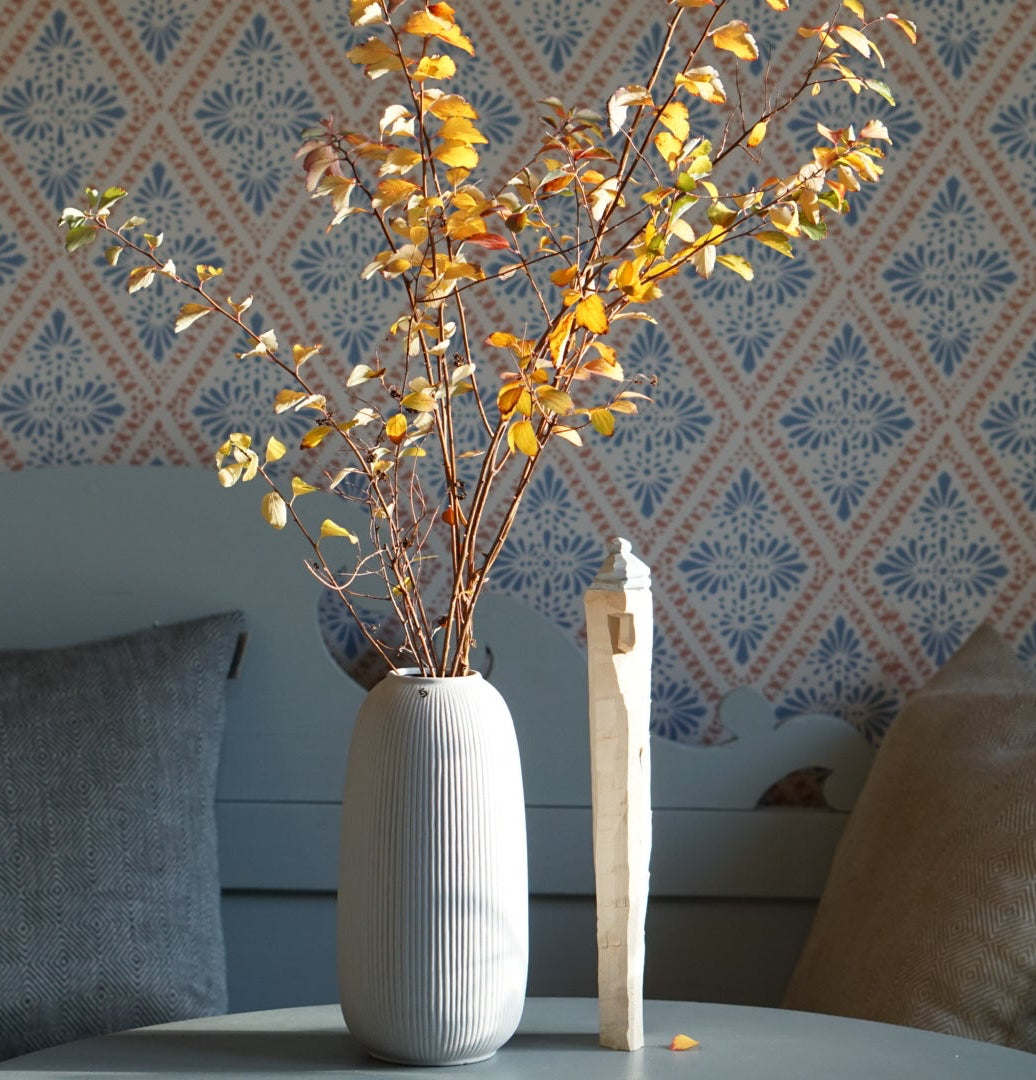 grsue Vase Åby in Grau mit Herbstlaub auf Tisch vor schwedischer Küchenbsnk